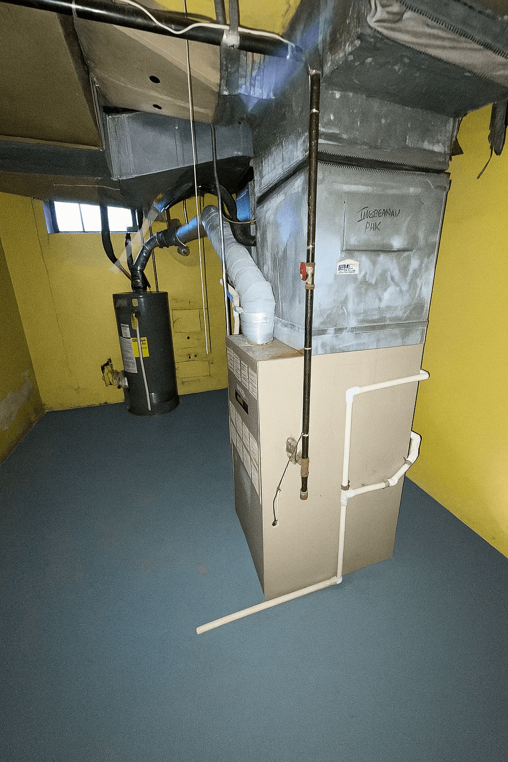 Example of furnace photographed from side angle showing connections, venting, and access panels